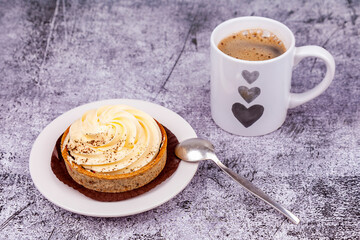 Cup with black coffee and tasty cake with cream on the table - 759176553