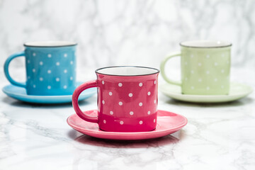 Obraz na płótnie Canvas Colorful Ceramic Mugs, Pink, Blue and Yellow with White Dots