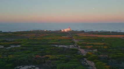 Beautiful evening sea landscape drone view. Light pink sky over endless ocean.