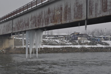Large pieces of icicles hang from the lower part of the metal bridge over the Vardar River in Skopje.
