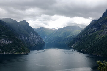 Magnificent Geirangerfjord in Norway. Fjord is surrounded by majestic mountains, covered with lush green trees, creating picturesque landscape
