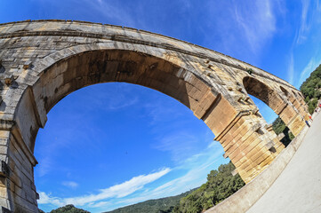 Historic Roman bridge Pont du Gard over Gard river near Vers-Pont-du-Gard town, France