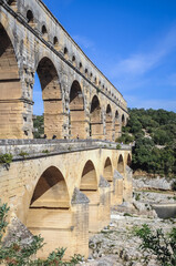 Aerial view of ancient Roman bridge Pont du Gard over Gard river near Vers-Pont-du-Gard town, France