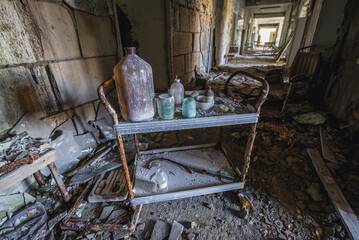 Old cart in Hospital MsCh-126 in Pripyat ghost city in Chernobyl Exclusion Zone, Ukraine - obrazy, fototapety, plakaty
