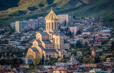 Foto op Plexiglas Aerial view with Holy Trinity Cathedral in Tbilisi city, Georgia © Fotokon