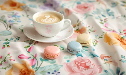  cappuccino and colorful macarons on a floral cloth with soft focus flowers © Klay