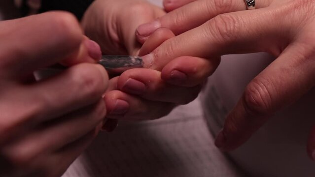 manicurist works with cuticle at home 