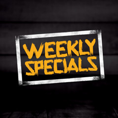 Weekly specials, gold font with white squares on black background
