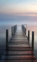 Poster The wooden dock goes into the lake in a foggy morning photo © A_A88