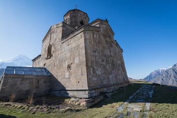 Tsminda Sameba - Trinity Church in Gergeti village near Stepantsminda, Georgia. Mount Kazbek on...