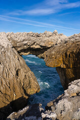 Cobijeru natural arch monument in Asturias, North coast of Sapin, in a sunny day.