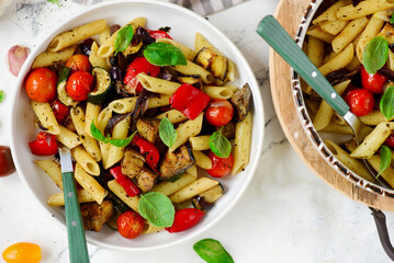 Roasted vegetables pasta with zuccini, tomato  and Basil  .top veiw.selective focus