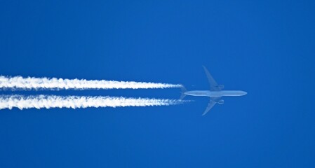 contrails chemtrails airplane smoke trail gases on blue sky background - obrazy, fototapety, plakaty