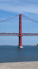 Lisbon 25 de Abril bridge red Tajo river engineering pillars stays tourism Portugal
