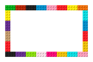 Naklejka premium Color frame composed of coloured plastic toy blocks. Colorful brick banner. Abstract vector background