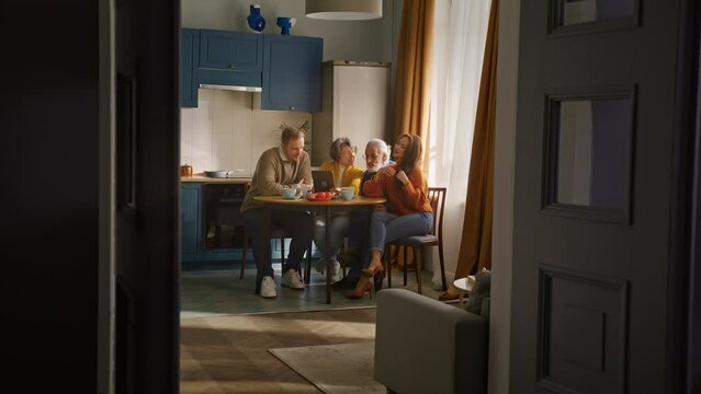Family sitting together and keeping digital tablet on desk
