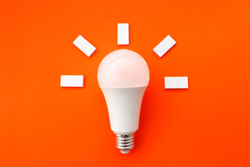 White light bulb with figures around it that express that a good idea has arisen