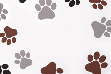 Pet paws on white background, dog paws pattern. National Puppy Day creative concept, top view