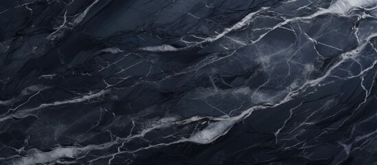 A detailed view of a black marble texture with striking white veins resembling flowing liquid waves...