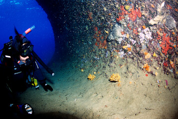 diver at the entrance to a submerged cave. Capo Caccia. Alghero. Sardinia, Italy