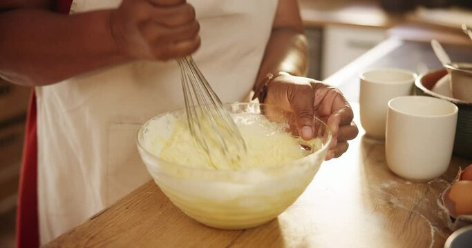 Closeup, hands or whisk for baking in kitchen with mixing bowl, wheat or meal prep for dessert or pudding in home. Person, cooking process or ingredients with eggs for cake, handmade cookies or snack