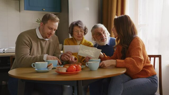 Family looking at postcards at cozy domestic atmosphere