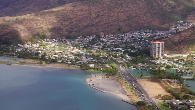 Honolulu suburban town nested on hills of scenic Hawaiian mountains. Iconic Hawaii Kai residential area. Houses build on steep hill overlooking ocean. Real estate background on Oahu island, buy offer