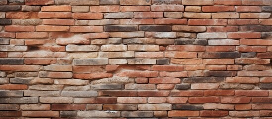 Obraz premium A detailed closeup of a brown brick wall showcasing the intricate brickwork and composite material used in the building construction process