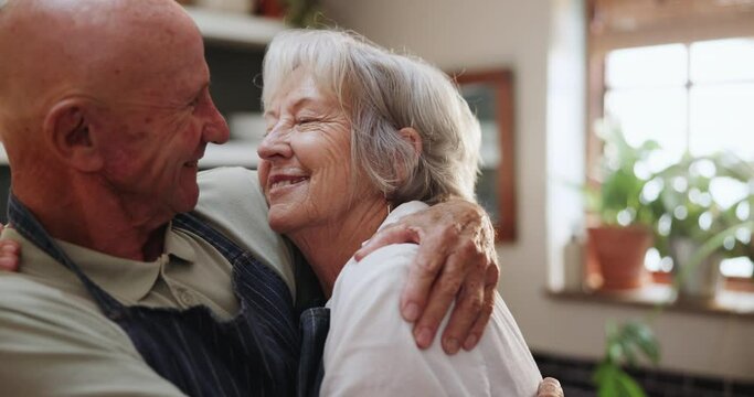 Senior, couple and kiss in kitchen with love, support and care in marriage and retirement. Elderly, man and woman embrace with kindness or gratitude for cooking dinner in home together with happy hug