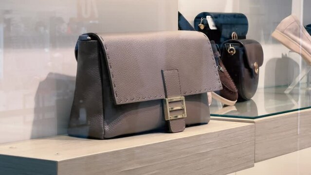 Women's leather handbags or faux leather bag on the shelf of an accessories store