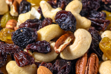 background with a cashew, hazelnuts, raisins and peanuts. Mixed nuts and raisins texture.