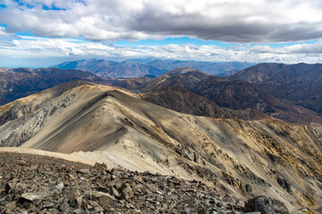 Rugged, rocky landscape of mountain ranges in Torlesse Tussocklands Park. Track to Castle Hill Peak, near Sheffield, Canterbury, new zealand south island. Mountains close to Christchurch. Mordor scene