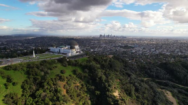 LOS ANGELES - 2.22.2024 - Excellent aerial footage passing over Griffith Observatory and moving towards the distant Los Angeles skyline.