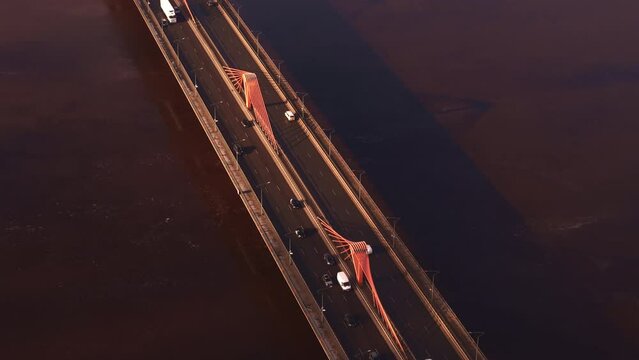Aerial top-down view of the Stone Bridge over the Daugava River in Riga with cars driving in morning light, Latvia
