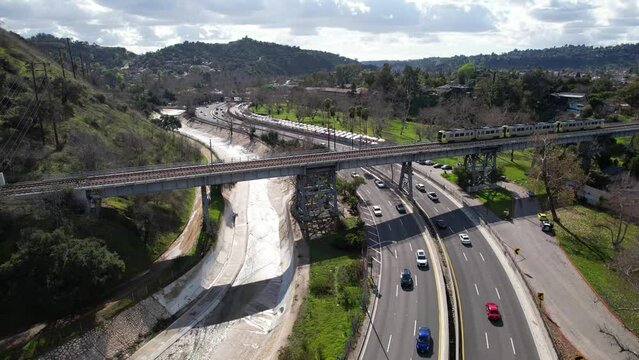 PASADENA - 2.22.2024 - Excellent aerial footage of a highway in South Pasadena, California, with a train passing on a bridge over it.