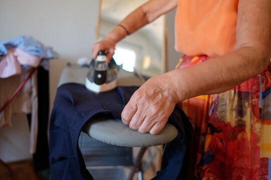 Woman ironing a skirt at home
