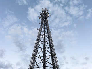 Tall Cell Phone tower landscape in sky with clouds 
