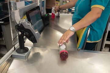 Anonymous cashier on check out process of buying goods