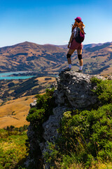 hiker girl admires the panorama of akaroa harbour and banks peninsula from the otepatotu scenic...
