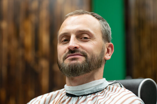 man having his beard cut and colored