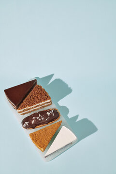 pieces of different cakes in one row on a stand