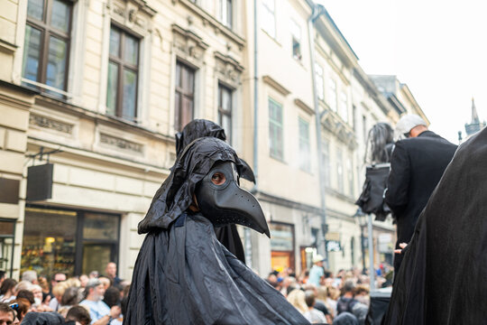 A man in a plague doctor costume in the city for Halloween