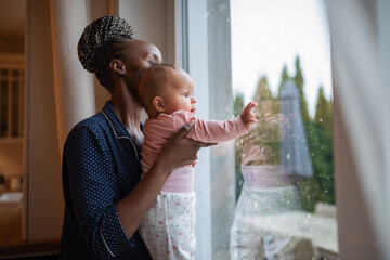 Excited baby watching falling snow