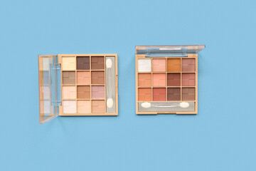 Eyeshadows palettes on blue background