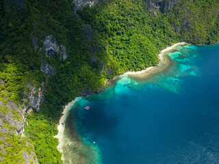 Pasandigan Cove with boats over clear water. Cadlao Island. El Nido, Palawan. Philippines.