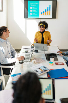 Group of colleagues discussing in meeting room