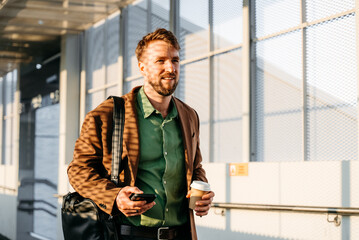 A man uses a phone at a railway station