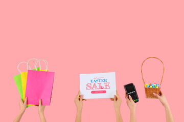 Women holding paper with text EASTER SALE, shopping bags, eggs and payment terminal on pink background