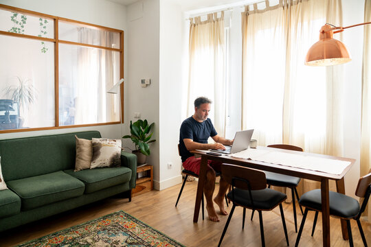 Man Using Laptop At Stylish Design Living Room
