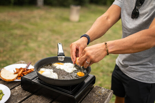 young man cooking in a picnic area in nature